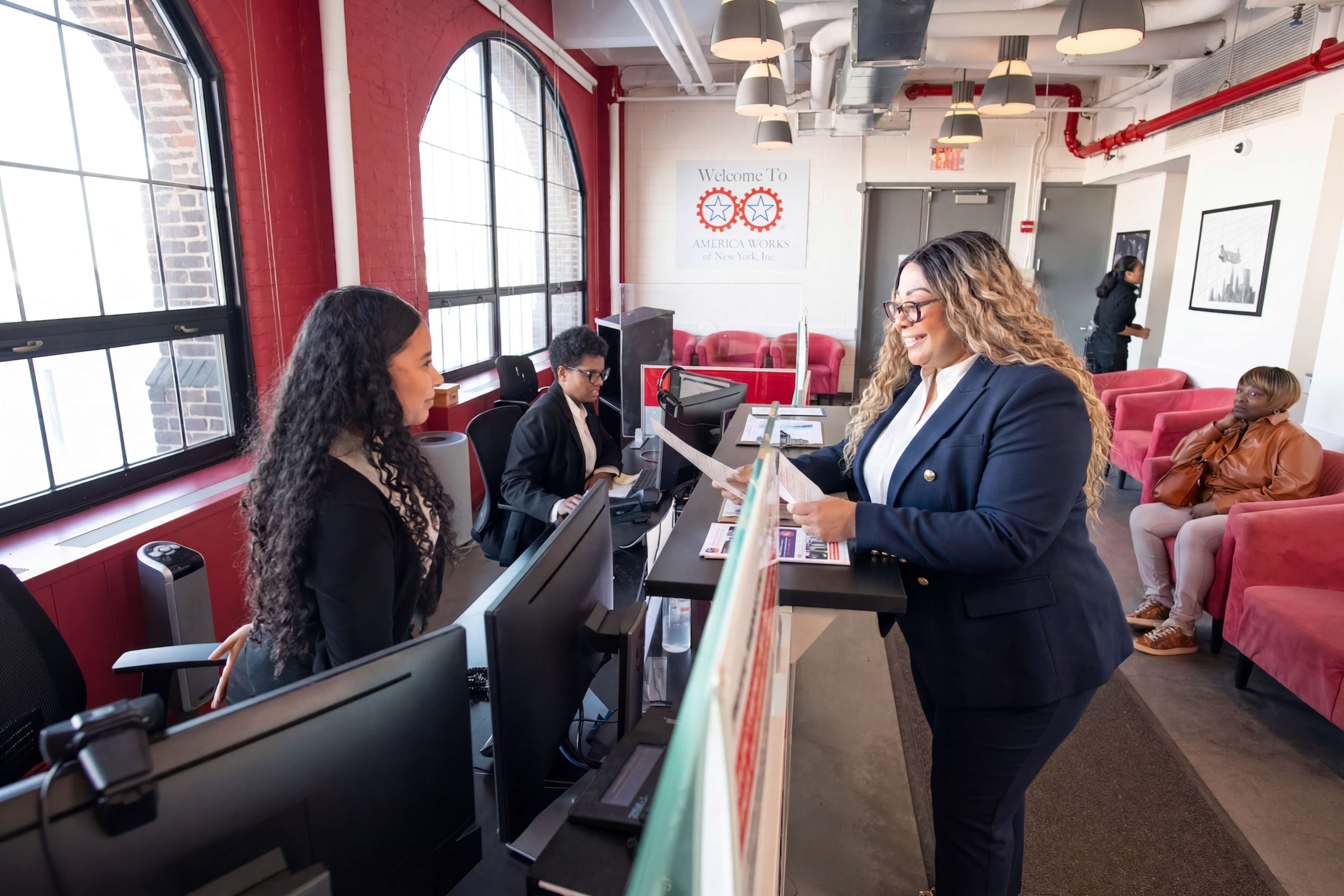 Staff member at front desk helping a visitor