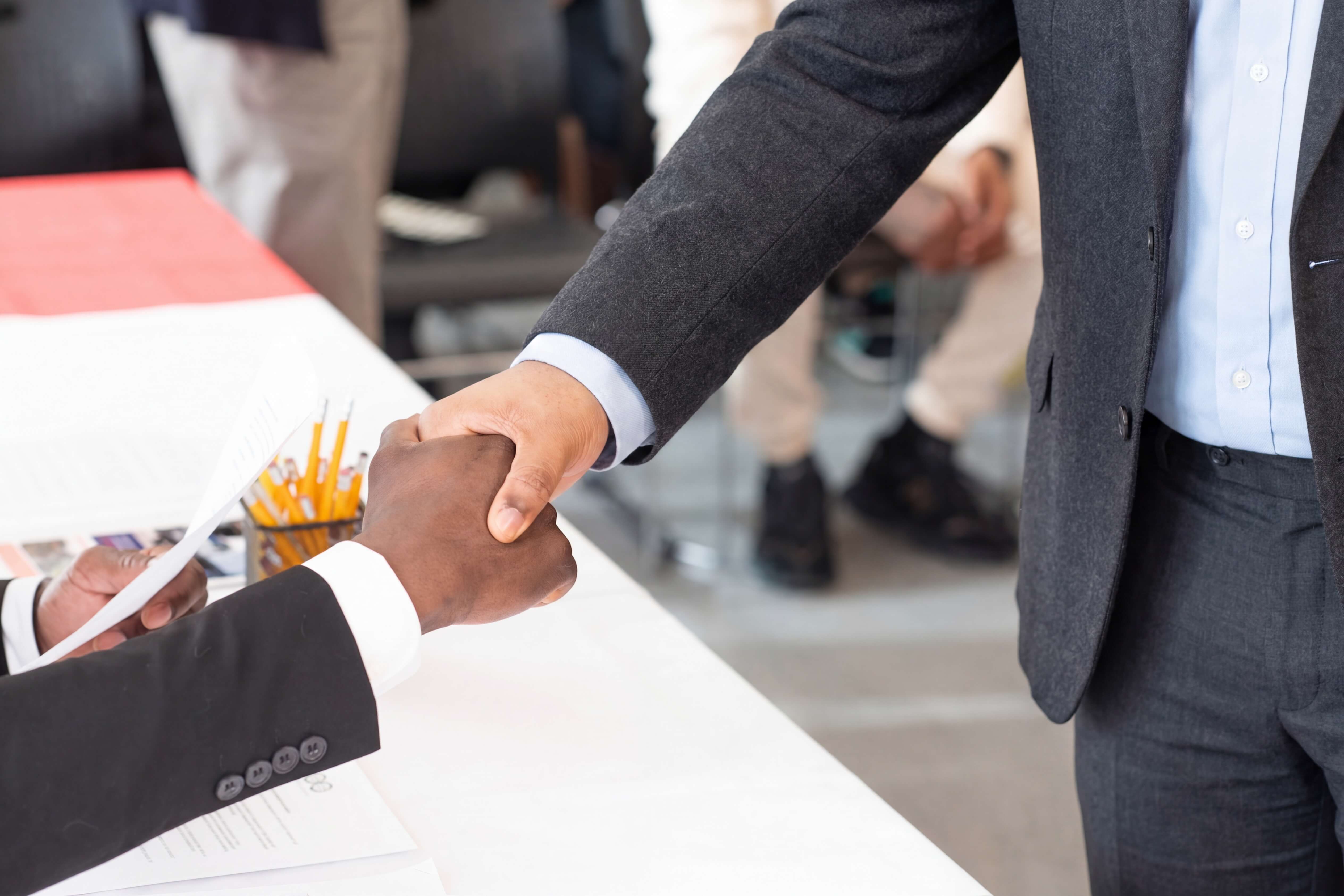 Professional handshake at hiring event